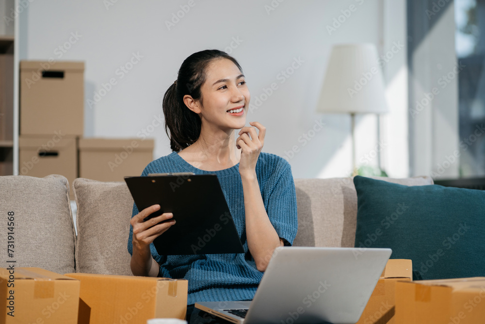 Business woman using laptop computer in office. Happy woman, entrepreneur, small business owner working online. Business woman using laptop computer in office. Happy woman, entrepreneur, small business owner working online.