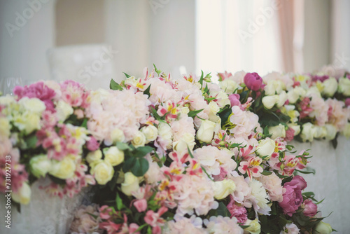 Beautiful flowers on table in wedding day. Table decor with flowers table numbers and candles. Boquet of flowers on arranged table. 