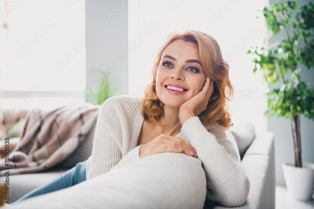 Portrait of gorgeous person sit sofa look away fantasize comfy domestic atmosphere apartment indoors Portrait of gorgeous person sit sofa look away fantasize comfy domestic atmosphere apartment indoors