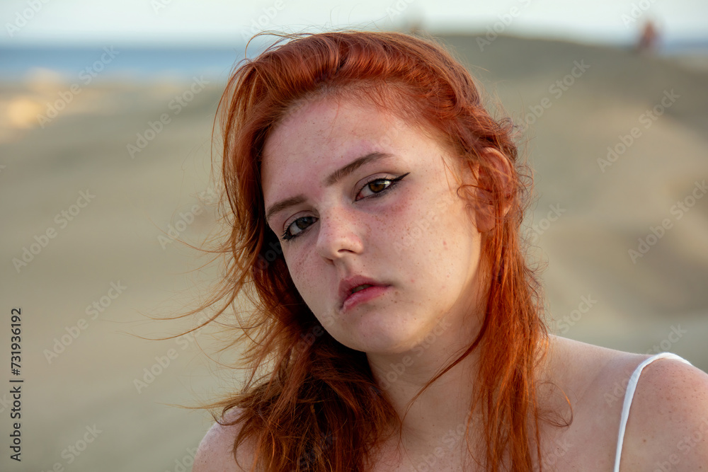 Young woman on the beach with windblown hair Young woman on the beach with windblown hair