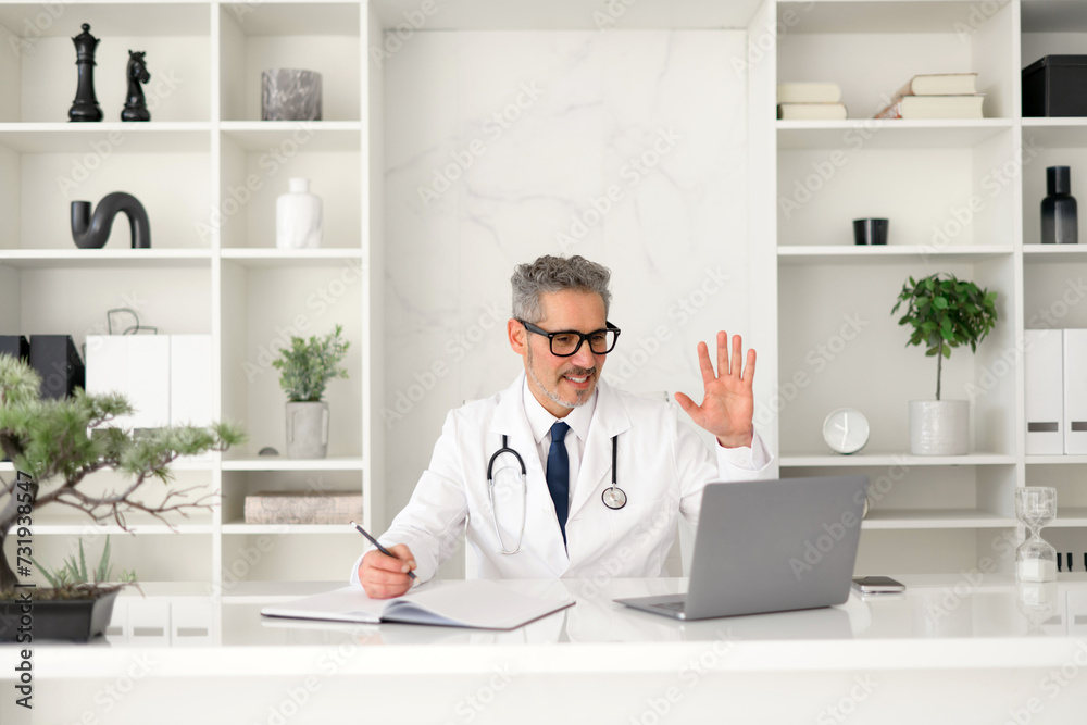 A grey-haired doctor waves in greeting, welcoming a patient to a virtual consultation, projecting a sense of cutting-edge healthcare service blended with traditional warmth and personal attention
