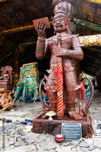 Art sculpture carving wooden buddha god and wood Thao Wessuwan or Vasavana Kuvera for thai people travel visit of Wat Tham Khao Prathun Temple at Ban Rai on January 14, 2024 in Uthai Thani, Thailand