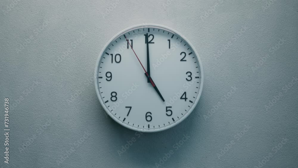Cinematic Shot of White Office Wall Clock with Red Second Hand that counting down the Seconds to Twelve. Concept: Anticipation, Running out of Time, Deadline, Tension and Passage of time.