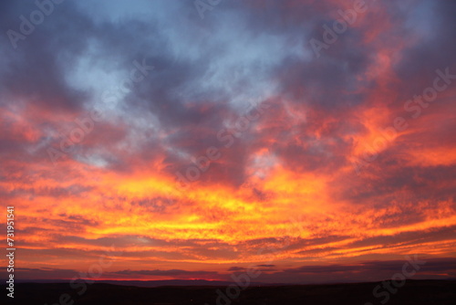 A red sky behind clouds. amazing sunset © Abdulkadir