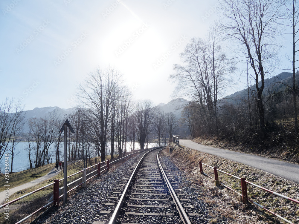 Fototapeta premium Railway tracks of the Bavarian Regiobahn between Hausham Fischhausen-Neuhaus, parallels the hiking trail along the west side of the Lake Schliersee 