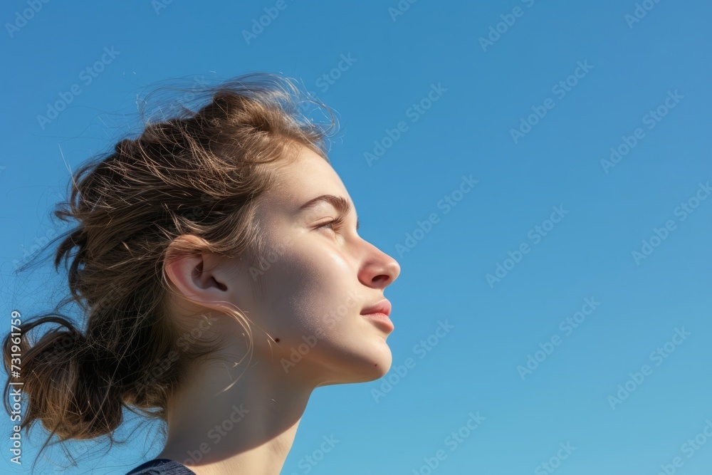 Youthful serenity against a blue sky, a profile embracing the calmness of the horizon
Youthful serenity against a blue sky, a profile embracing the calmness of the horizon