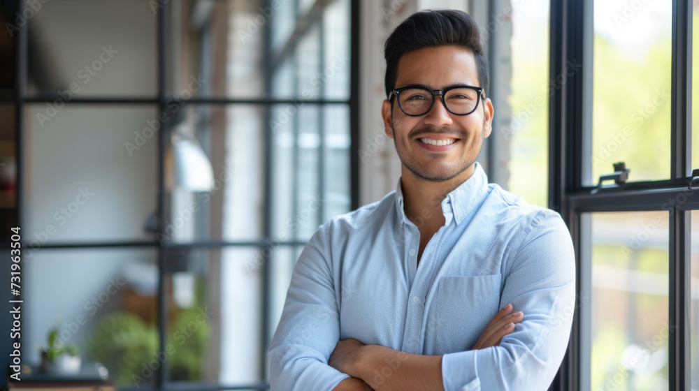 A confident man stands with arms crossed in a modern office environment, embodying leadership and professionalism with his team in the background. A confident man stands with arms crossed in a modern office environment, embodying leadership and professionalism with his team in the background.