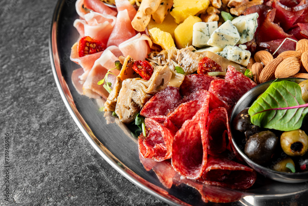 Antipasto plate with ham, prosciutto, salami, cheese, vegetables and olives