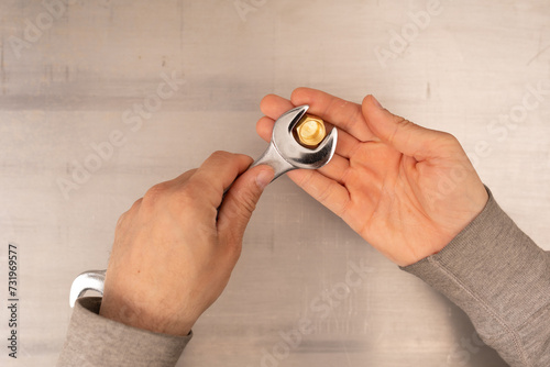 Metal wrench in male hand i...