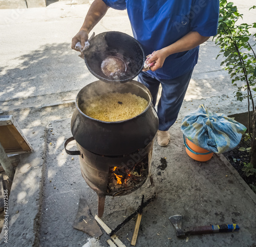 The process of preparing classic Uzbek pilaf in the ancient city of Bukhara in Uzbekistan photo