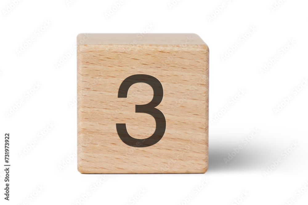 A single wooden block prominently displays a black number three, isolated cutout from background. A single wooden block prominently displays a black number three, isolated cutout from background.