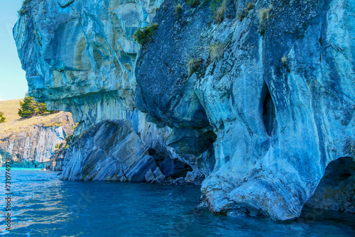 Turquoise water of General Cerrerra Lake splashing against blue Marble caves or Cuevas de Marmol at General Cerrerra Lake. Location Puerto Sanchez, Chile