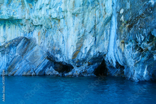 Turquoise water of General Cerrerra Lake splashing against blue Marble caves or Cuevas de Marmol at General Cerrerra Lake. Location Puerto Sanchez, Chile