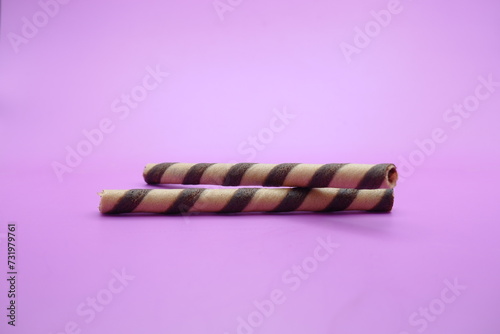 wafer stick isolated purple background. 2 chocolate flavored wafer sticks.