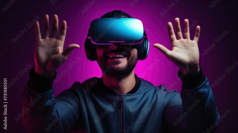 A young man using VR glasses, happy and excited making a winner gesture with arms raised over Isolated on a gray background studio portrait. VR, future, gadgets, technology, neon sty. A young man using VR glasses, happy and excited making a winner gesture with arms raised over Isolated on a gray background studio portrait. VR, future, gadgets, technology, neon sty.