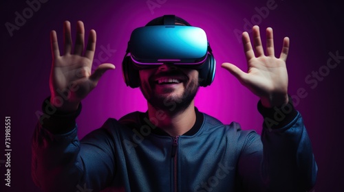A young man using VR glasses, happy and excited making a winner gesture with arms raised over Isolated on a gray background studio portrait. VR, future, gadgets, technology, neon sty.