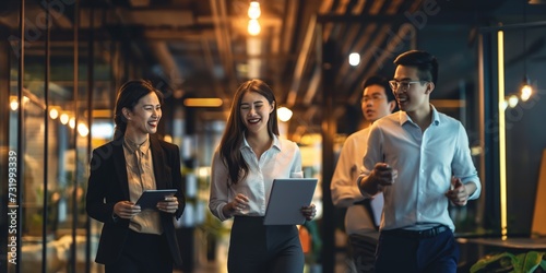 Night, tablet and business people walking in office after finishing work task. Tech, overtime and Asian woman with group of friends going home after working late on sales project in dark workplace