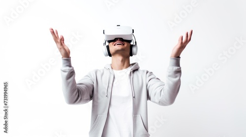 A young man using VR glasses, happy and excited making a winner gesture with arms raised over Isolated on a white background studio portrait. VR, future, gadgets, technology,