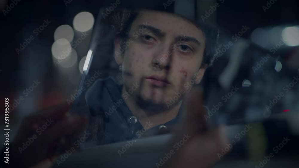 Young Lost Man with Suitcase Finding Broken Mirror on Urban Street at Night Young Lost Man with Suitcase Finding Broken Mirror on Urban Street at Night