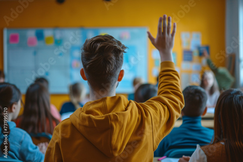 A boy raising his hand in class at school