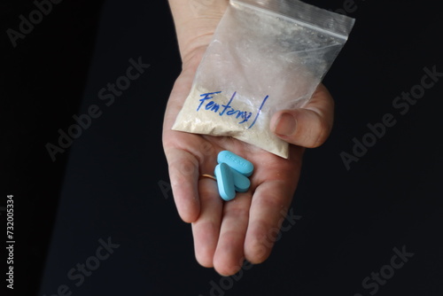 Принти на полотні Woman holding a pack with fentanyl powder and pills to illustrate the drug addic