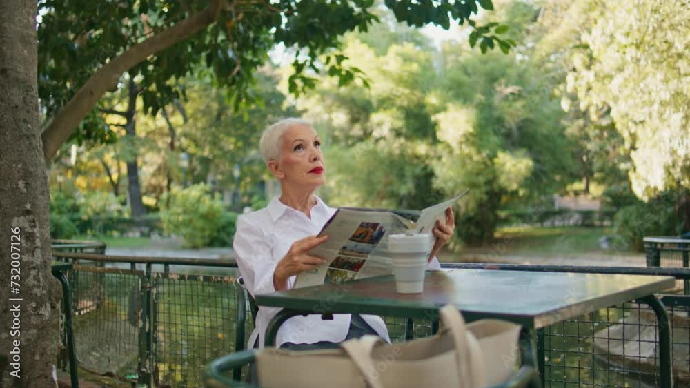 Older woman resting terrace with newspaper. Peaceful stylish lady enjoy morning Older woman resting terrace with newspaper. Peaceful stylish lady enjoy morning