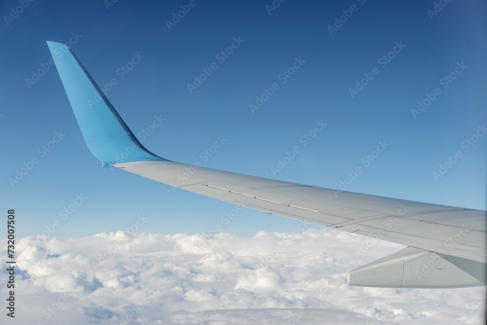 Obraz premium Aircraft Wing View From Airplane Window Seat Blue Sky Cloud