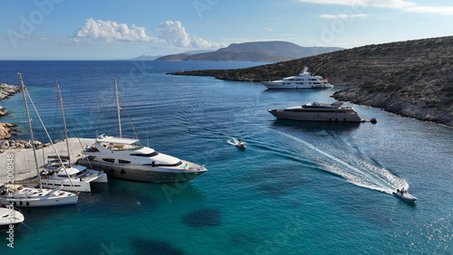 Aerial drone photo of small port of Schoinousa island a safe harbour to yachts and sail boats featuring small beach of Myrsini covered in Almirikia trees, Small Cyclades, Greece photo