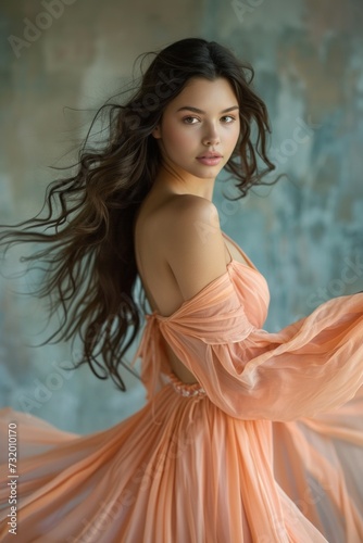 a woman elegantly adorned in a flowing peach - colored long dress