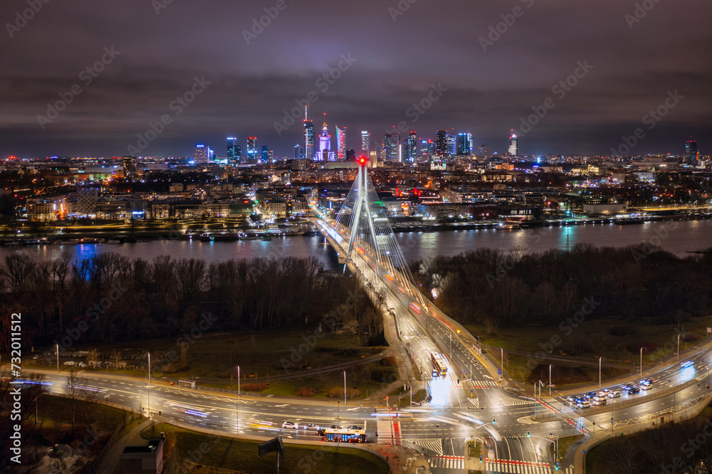 Swietokrzyski Bridge over the Vistula River with a panoramic view of the center of Warsaw at night. Poland
