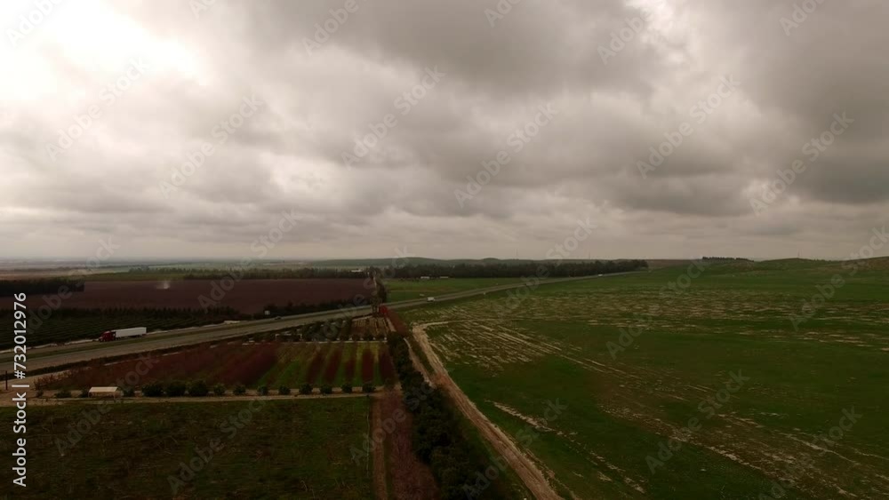 Aerial Forward Scenic Shot Of Dry Agricultural Field On Hills Under Clouds In Sky - Bakersfield, California Aerial Forward Scenic Shot Of Dry Agricultural Field On Hills Under Clouds In Sky - Bakersfield, California