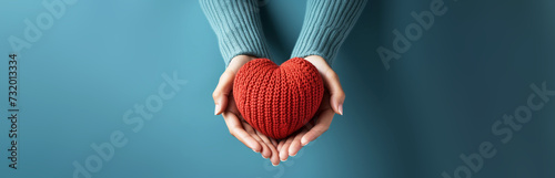 Woman hand holding a red heart shape