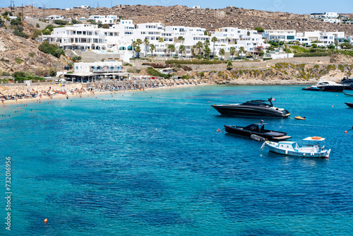Psarou beach in Mykonos, Greece, umbrella and luxury beach services. Psarou beach is the favorite of international stars, truly a paradise with spectacular landscape and all its comforts