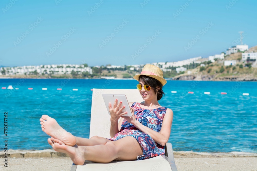 Woman Using Her Tablet With Ocean Background