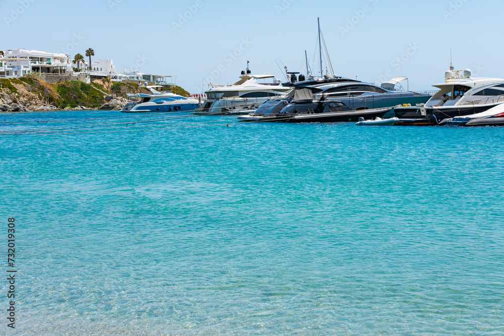 Obraz premium Psarou beach in Mykonos, Greece, umbrella and luxury beach services. Psarou beach is the favorite of international stars, truly a paradise with spectacular landscape and all its comforts