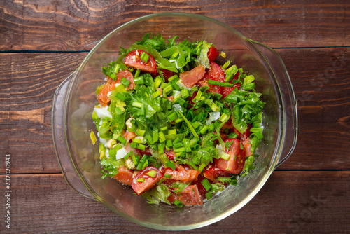 Vegetable salad avocado cherry tomato salted salmon boiled egg with lemon dressing in a plate