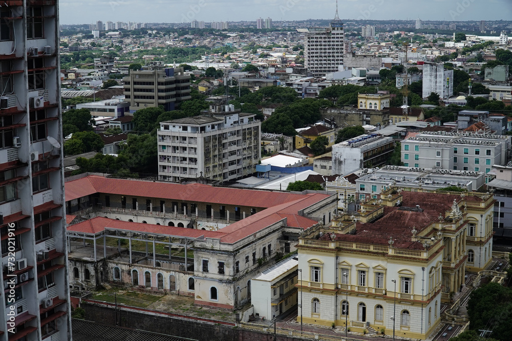 City panorama of Manaus, Amazonas, Brazil. The Palace of Justice in the foreground and older buildings from the rich rubber era decaying in the tropical humidity.