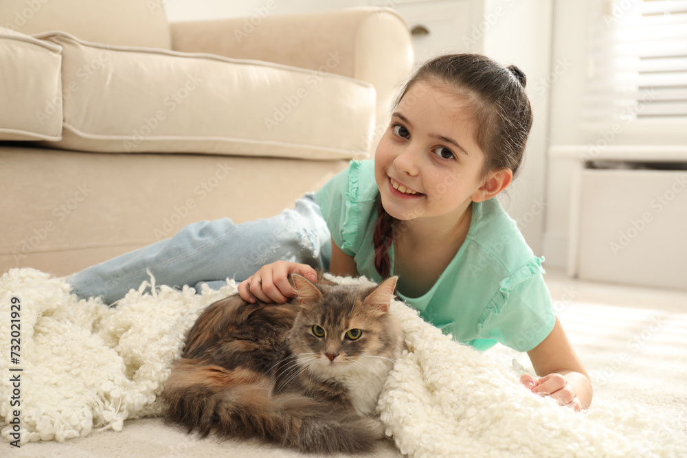 Cute little girl with cat lying on carpet at home. First pet Cute little girl with cat lying on carpet at home. First pet