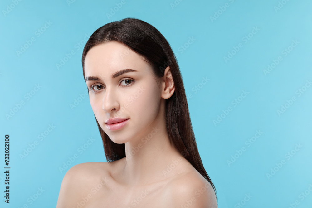 Portrait of beautiful young woman on light blue background. Space for text Portrait of beautiful young woman on light blue background. Space for text
