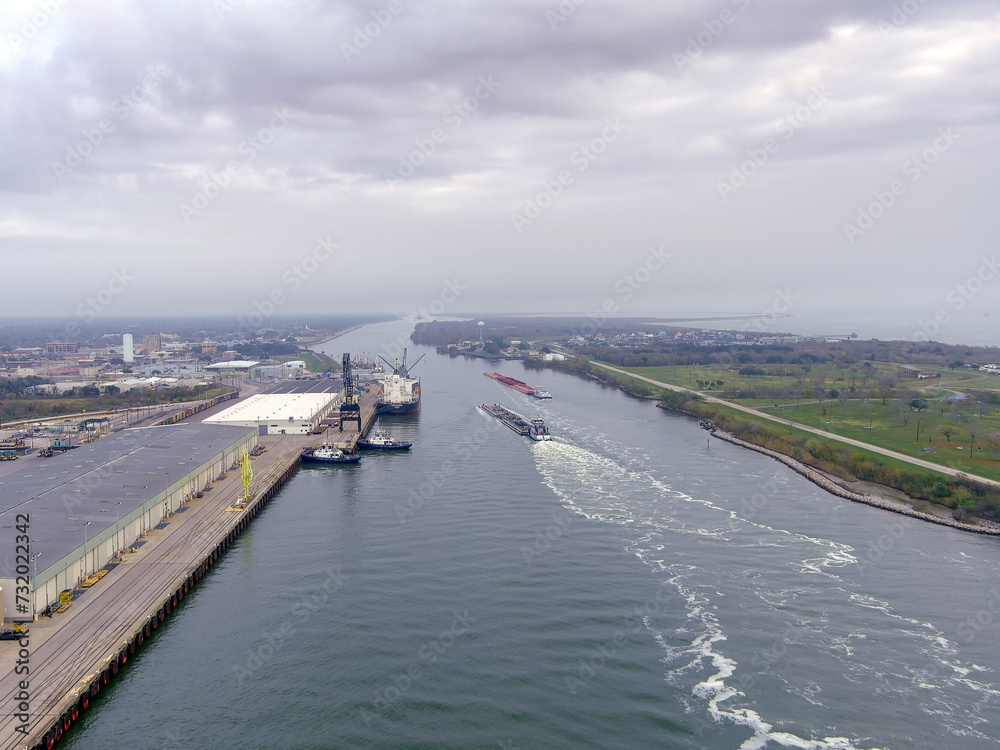 Aerial view of Tugboats and Barges on the Sabine Lake Causeway in Port Arthur Texas Aerial view of Tugboats and Barges on the Sabine Lake Causeway in Port Arthur Texas
