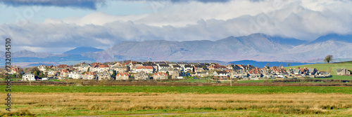 Panorama of Ravenstown, on the Cartmel Peninsula with the lake district fells in the distance.