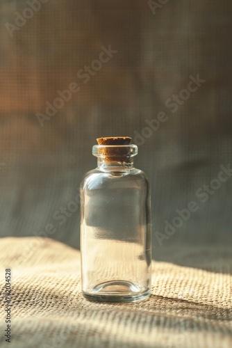 a small glass bottle on a beige background