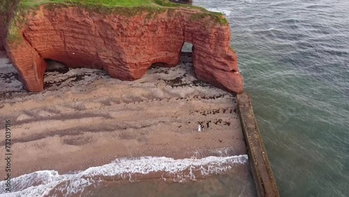 red langstone rock next to the sea and on the beach at dawlish warren photo