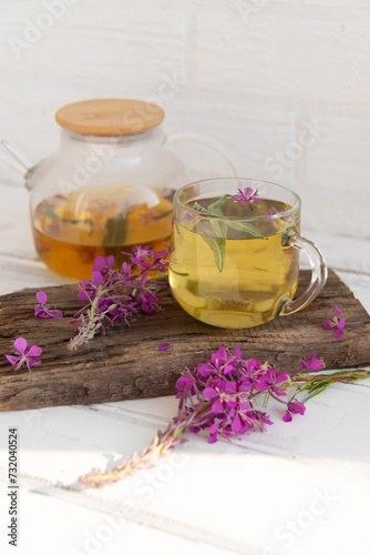 A drink (decoction) from the leaves and flowers of the medicinal plant ivan-tea (cypress, epilobium) in a mug. Traditional medicine, collection of useful herbs. Alternative medicine