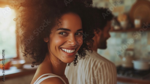 Simple yet charming image of a couple sharing laughter and smiles in the kitchen