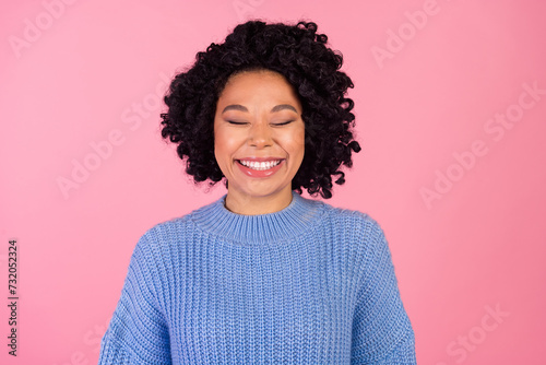 Photo portrait of attractive young woman cheerful smile closed eyes wear trendy blue knitwear clothes isolated on pink color background