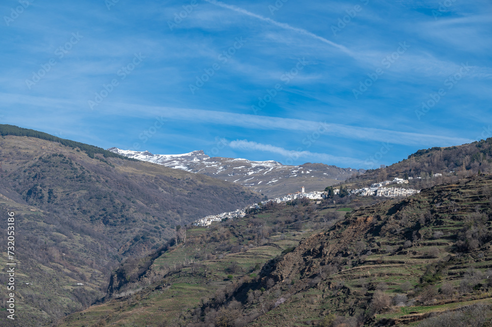 View of the picturesque Granada village of Capileira (1436 m altitude) in the Alpujarra on a sunny winter morning View of the picturesque Granada village of Capileira (1436 m altitude) in the Alpujarra on a sunny winter morning