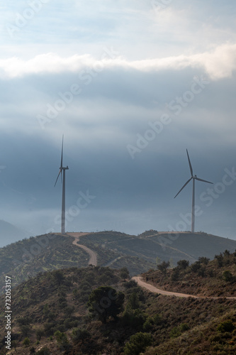 View of wind turbines in the Alpujarra mountains of Granada (Spain) on a misty winter morning