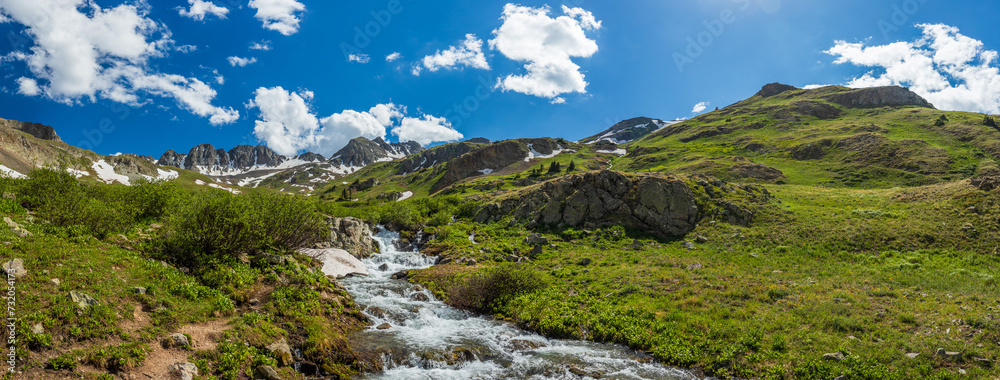 mountain landscape panorama in the summer afternoon with river and tundra hills 