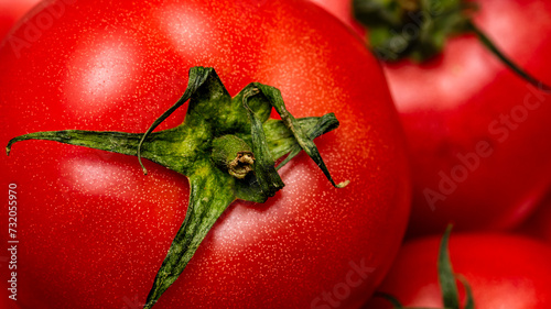 Close up of ripe red tomato, tomatoes background. © Vlad Ispas